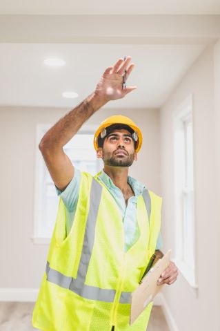 Man Wearing Safety vest Looking at the Ceiling